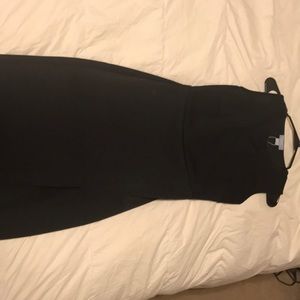 Tight fitting black dress. Very elegant.